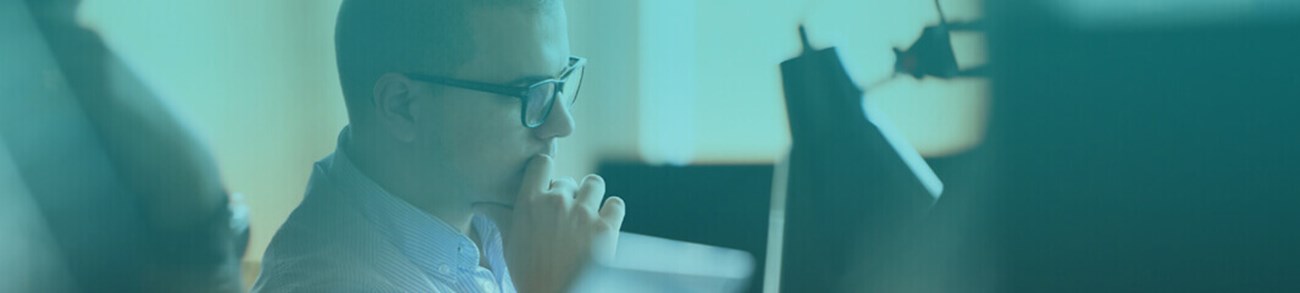 Software developer working on computer at modern office